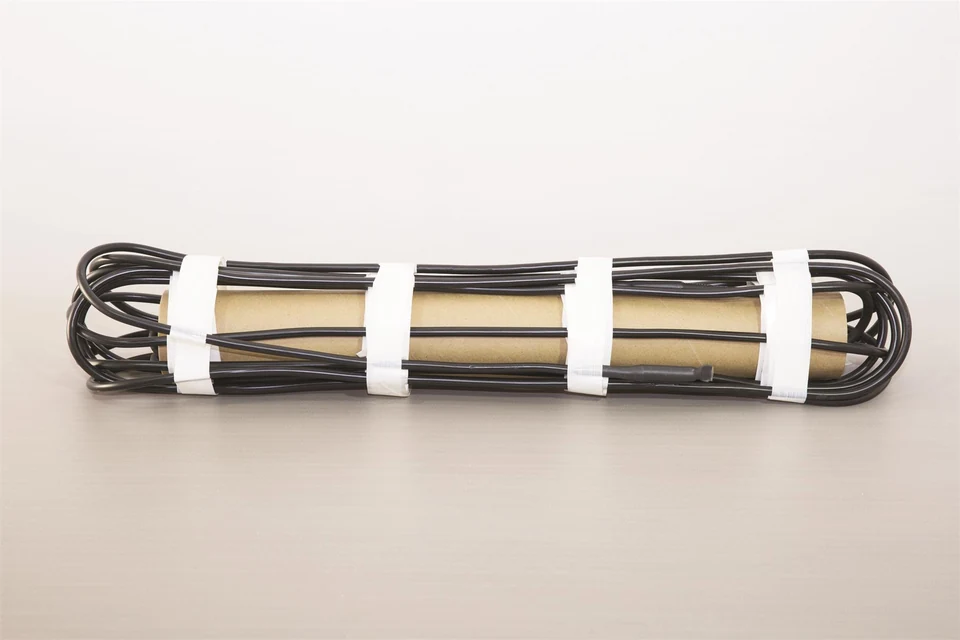 Black snow-melting cable bundled around a cardboard tube.