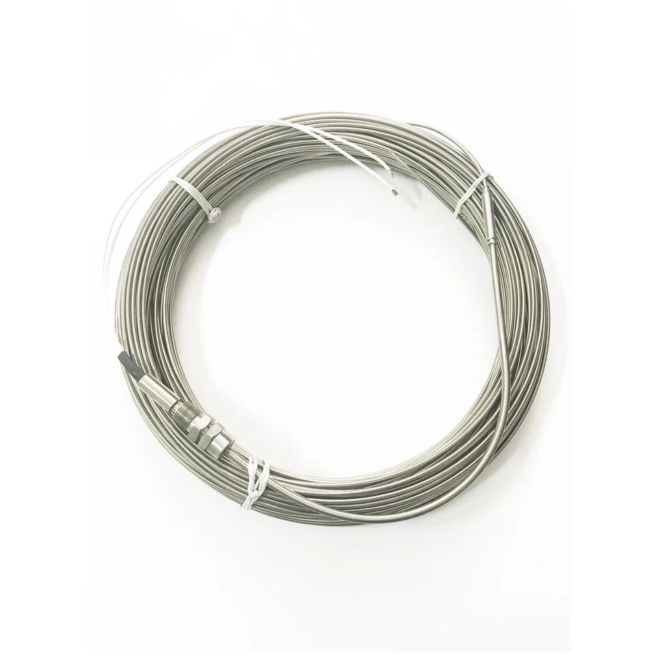Coiled mineral-insulated heating cable with white leads and threaded fittings.