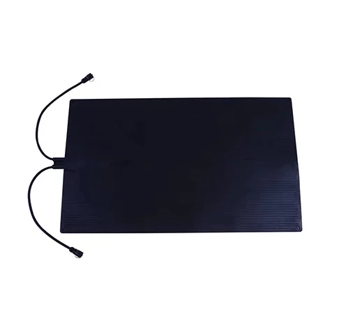 Black rectangular snow-melting mat with two connector leads.