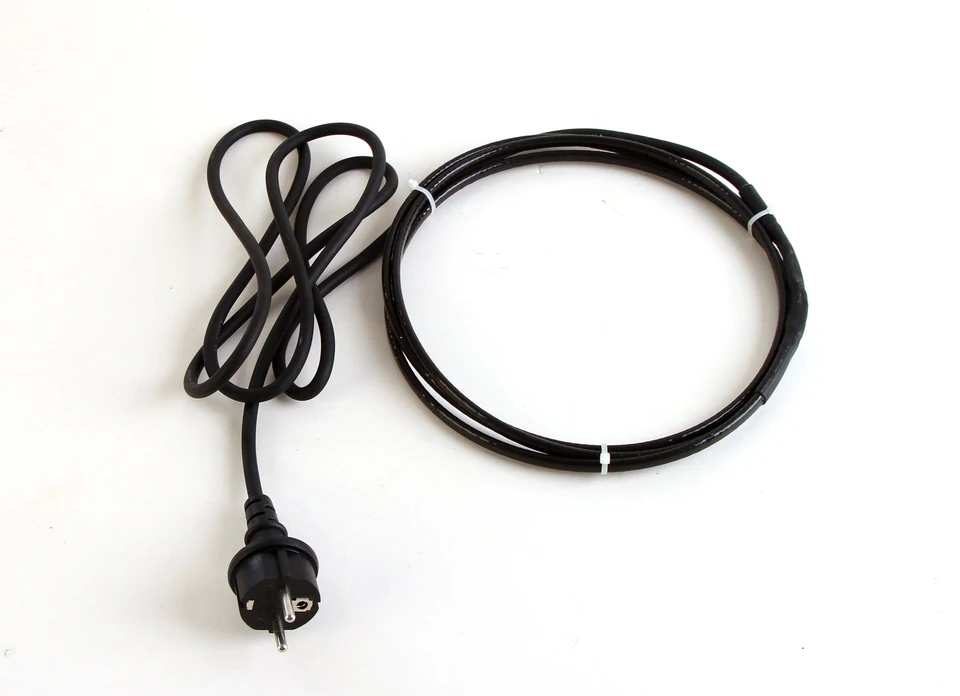 Coiled black roof and gutter de-icing cable with a two-pin power plug.